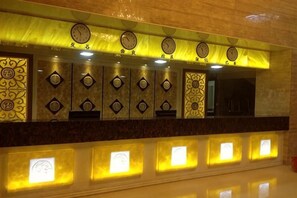 A wall with clocks and illuminated panels, likely indicating a lobby or common area. - Jiaoling Shun'an Hotel (Jiaoling)