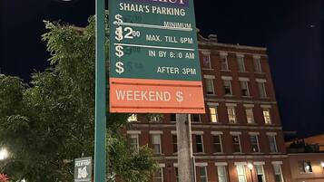 A parking sign with rates for Warehouse District parking, including specific charges for weekdays and weekends.