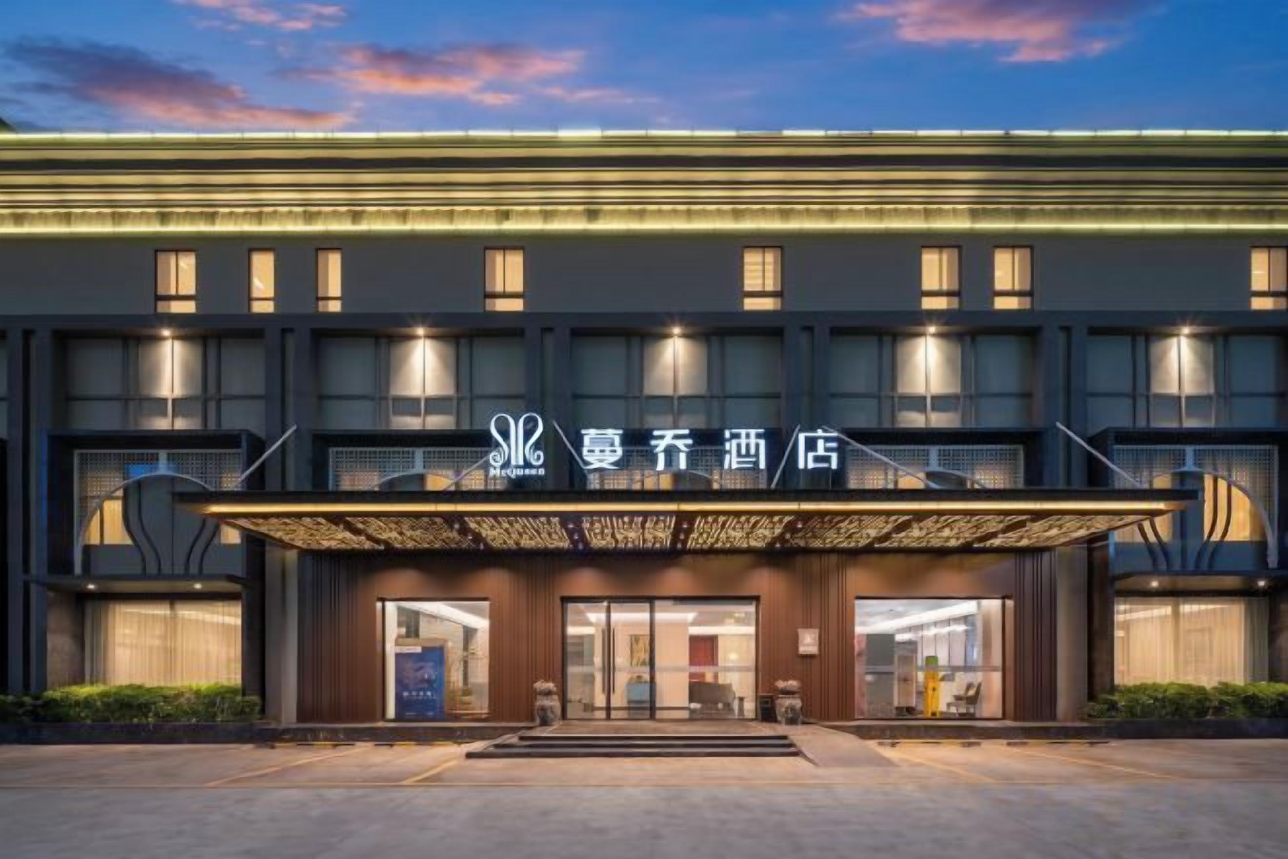 A hotel with a modern facade, multiple floors, and a prominent entrance with a canopy.