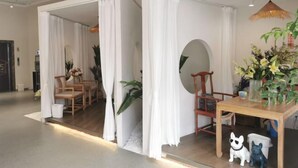 A modern interior with a wooden dining table, chairs, and a small dog figurine. - Yuting Express Hotel (Hai'an)