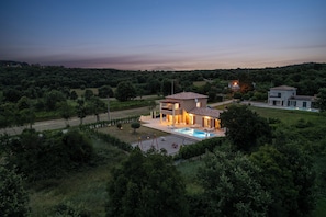 A modern two-story house with a swimming pool, surrounded by lush greenery and a clear sky. - Villa Erla (Sveta Nedelja)