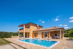 A two-story house with a swimming pool, outdoor seating, and a view of the surrounding greenery. - Villa Erla (Sveta Nedelja)