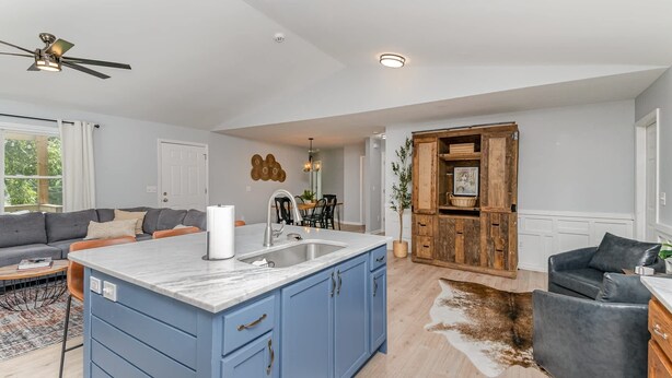 A modern kitchen with blue cabinets, a marble island, and a built-in sink. - Relaxing Belmont Escape, 4BR, Pet Friendly (Belmont)