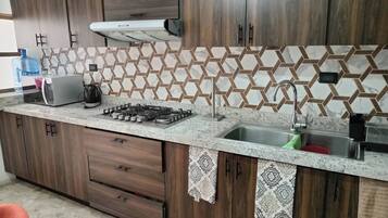 Fridge, microwave, stovetop, coffee/tea maker