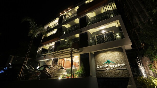 A multi-story building with balconies and a sign in a local language.