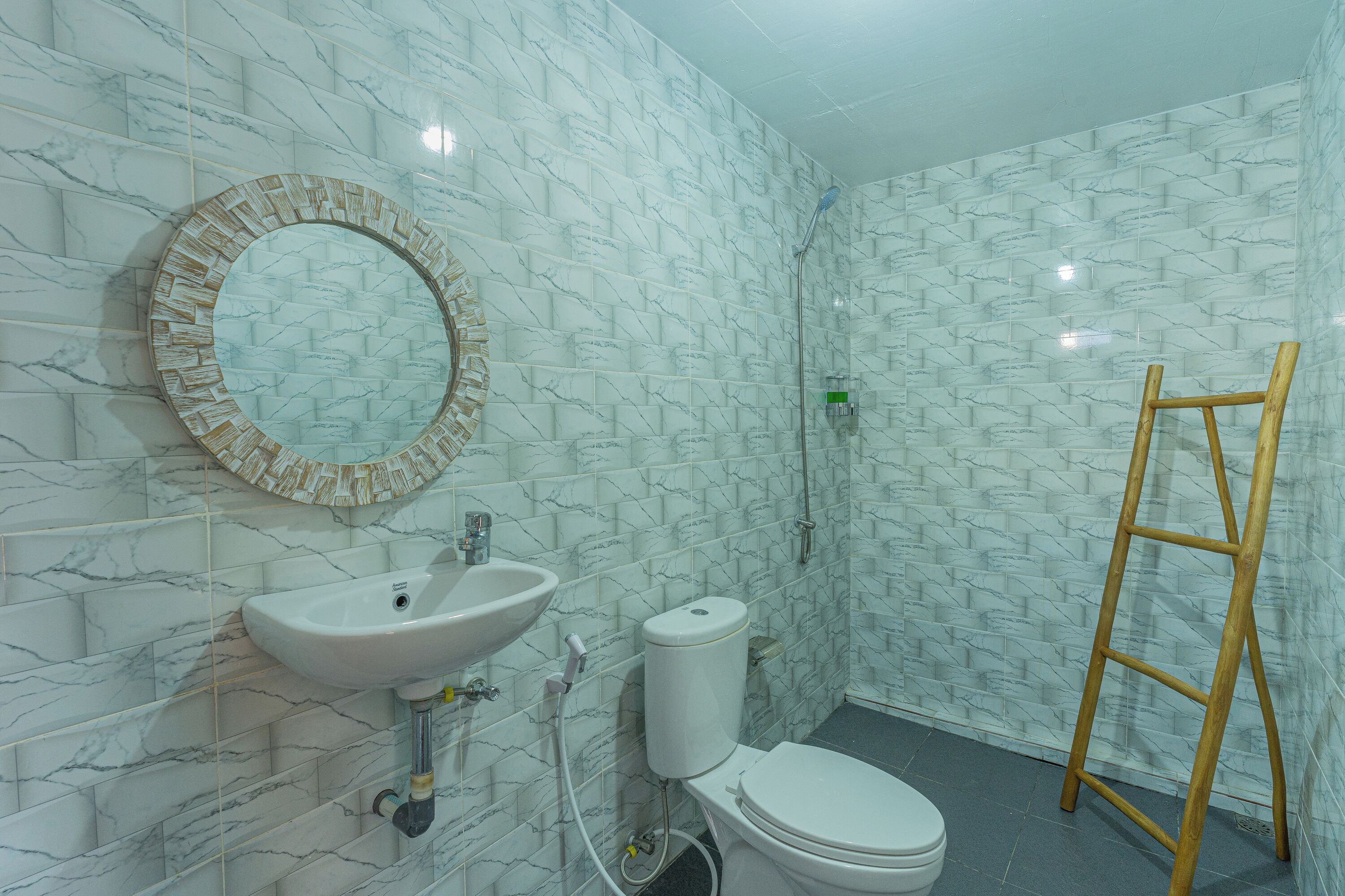 A bathroom with a sink, toilet, and shower.