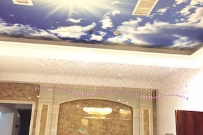A room with a ceiling mural of clouds and sun, a marble fireplace, and a string of lights. - Taizhou 1981 Hotel (Sanmen Shangyang Road Branch) (Sanmen)