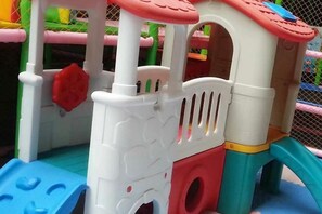 A children's play structure with a slide, climbing area, and enclosed play space. - Zhongcheng Holiday Hotel (Shijiazhuang)