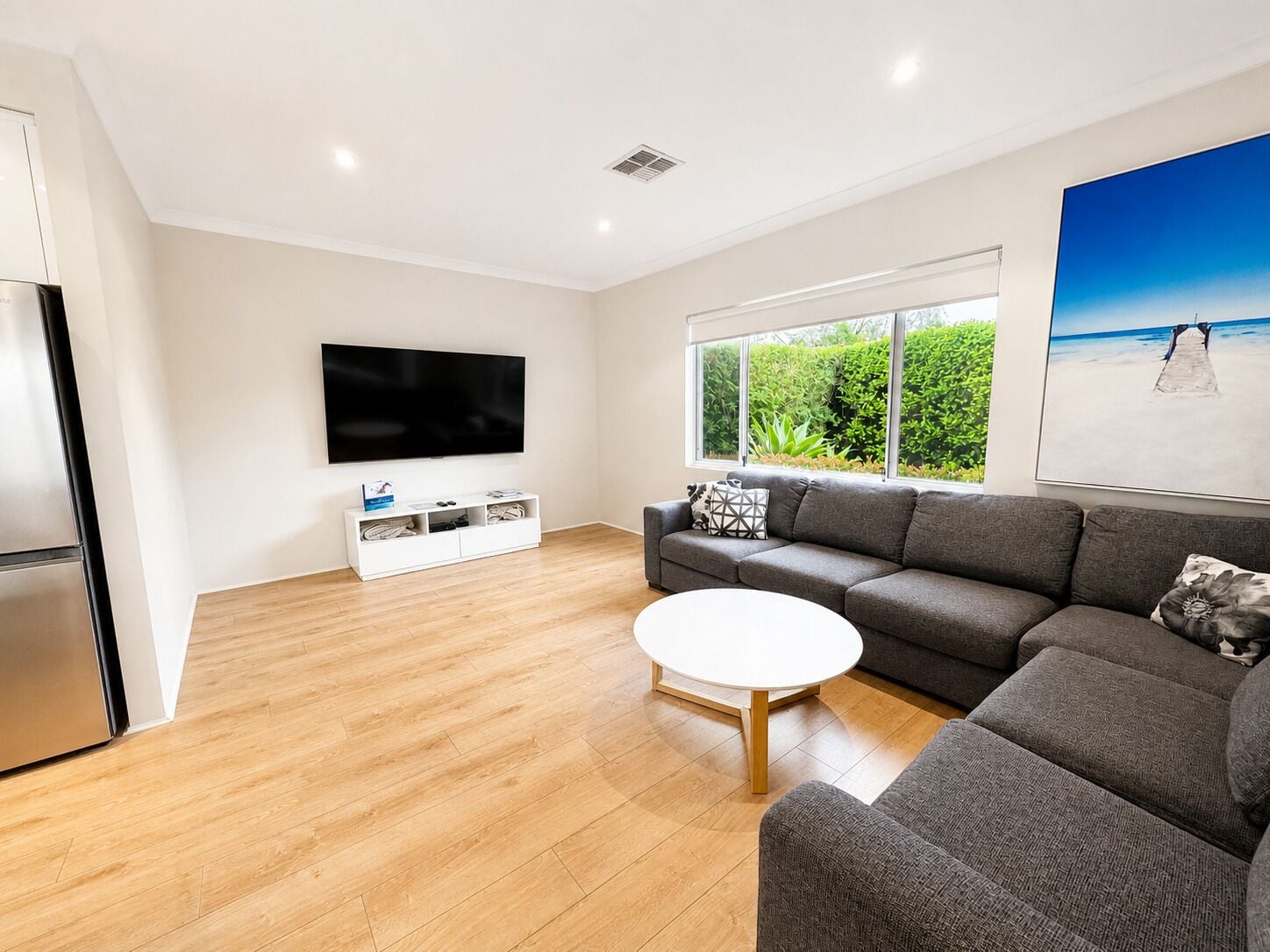 Deluxe House | Living area | 65-inch TV with digital channels, DVD player