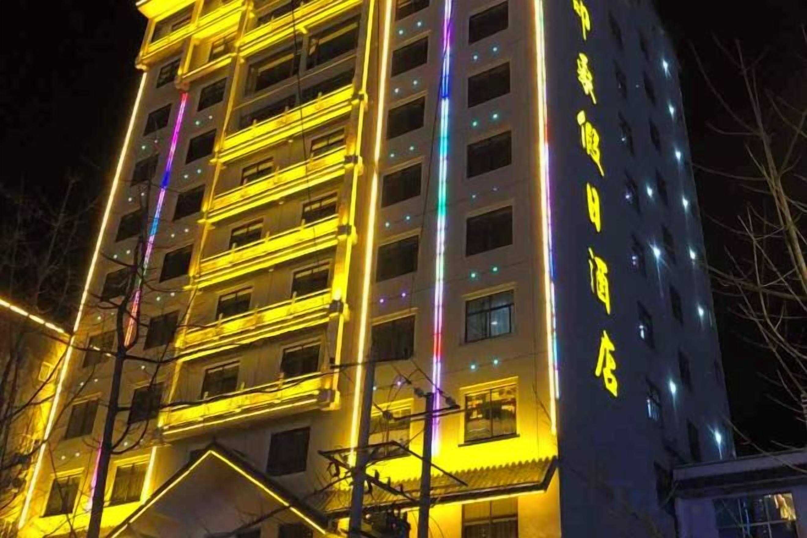 Un immeuble d’hôtel à plusieurs étages, doté d’un éclairage extérieur et d’une signalétique lumineux.