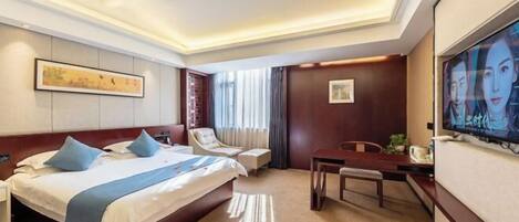 Una habitación de hotel con una cama grande, un escritorio, una silla, un televisor y obras de arte en las paredes.