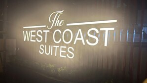A sign for "The West Coast Suites" with a modern design and clear lettering. - Hotel The West Coast (Vasai)