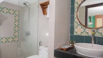 A bathroom with a shower, toilet, and sink.