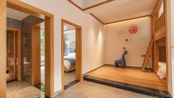 A modern interior with a wooden floor, a small giraffe decoration, and a staircase.