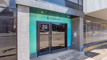 A modern building with a green awning and the number 20 on the entrance.