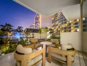 A modern outdoor seating area with a view of a cityscape at dusk.