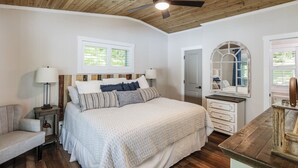A bedroom with a bed, bedside tables, a dresser, a mirror, and a ceiling fan. - The Overlook at Langford - Private dock with SUPs, Kayaks, and Ping Pong (Leesville)