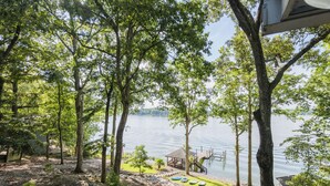 A lakeside cabin with a dock, outdoor seating, and a gazebo overlooking the water. - The Overlook at Langford - Private dock with SUPs, Kayaks, and Ping Pong (Leesville)