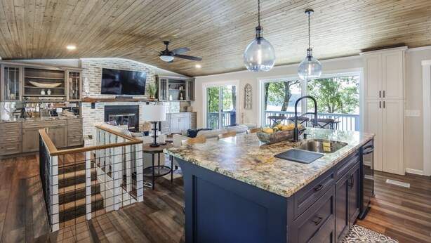 A spacious kitchen with a large island, wooden ceiling, and modern appliances. - The Overlook at Langford - Private dock with SUPs, Kayaks, and Ping Pong (Leesville)