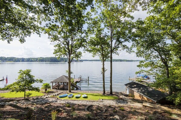 A lakeside property with a dock, a gazebo, and a small shed. - The Overlook at Langford - Private dock with SUPs, Kayaks, and Ping Pong (Leesville)