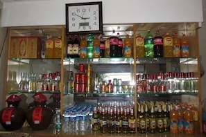 A liquor store with shelves stocked with various bottles and boxes.