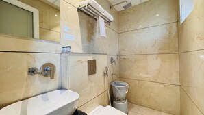A bathroom with a white sink, toilet, and shower. - Hotel Rudhav Palace (Ujjain)