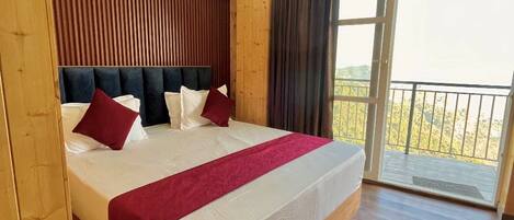 A wooden room with a bed, ceiling fan, and large windows.