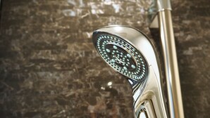 A chrome showerhead with a circular pattern. - Kamishihoro Hotel (Kamishihoro)