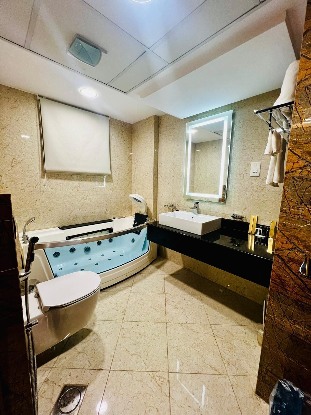 A modern bathroom with a bathtub, a sink, and a large mirror.