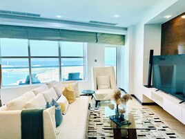 Executive Suite, Sea View | Living area | 65-inch Smart TV with satellite channels