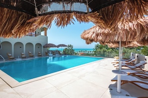 Seasonal outdoor pool, open 9:00 AM to 7:00 PM, pool umbrellas