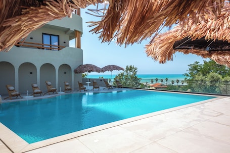 Seasonal outdoor pool, open 9:00 AM to 7:00 PM, pool umbrellas. Emara Boutique Hotel
