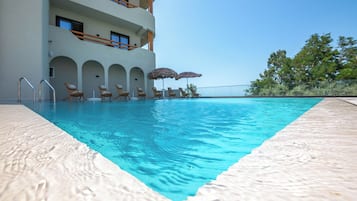 Seasonal outdoor pool, open 9:00 AM to 7:00 PM, pool umbrellas