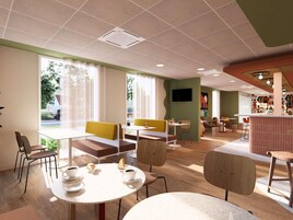 Um café moderno com mesas e cadeiras redondas, uma televisão na parede e grandes janelas com vista para o exterior.