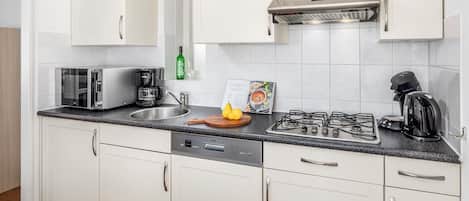 Fridge, stovetop, dishwasher, coffee/tea maker