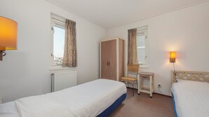 A small, clean room with two single beds, a desk, a wardrobe, and a chair. - Detached villa for 6 persons with sauna (Hageweg 'T Centrum)