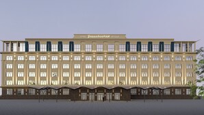 A large, multi-story building with a symmetrical facade, numerous windows, and a flat roof. - Ulaanbaatar Hotel (Ulaanbaatar)