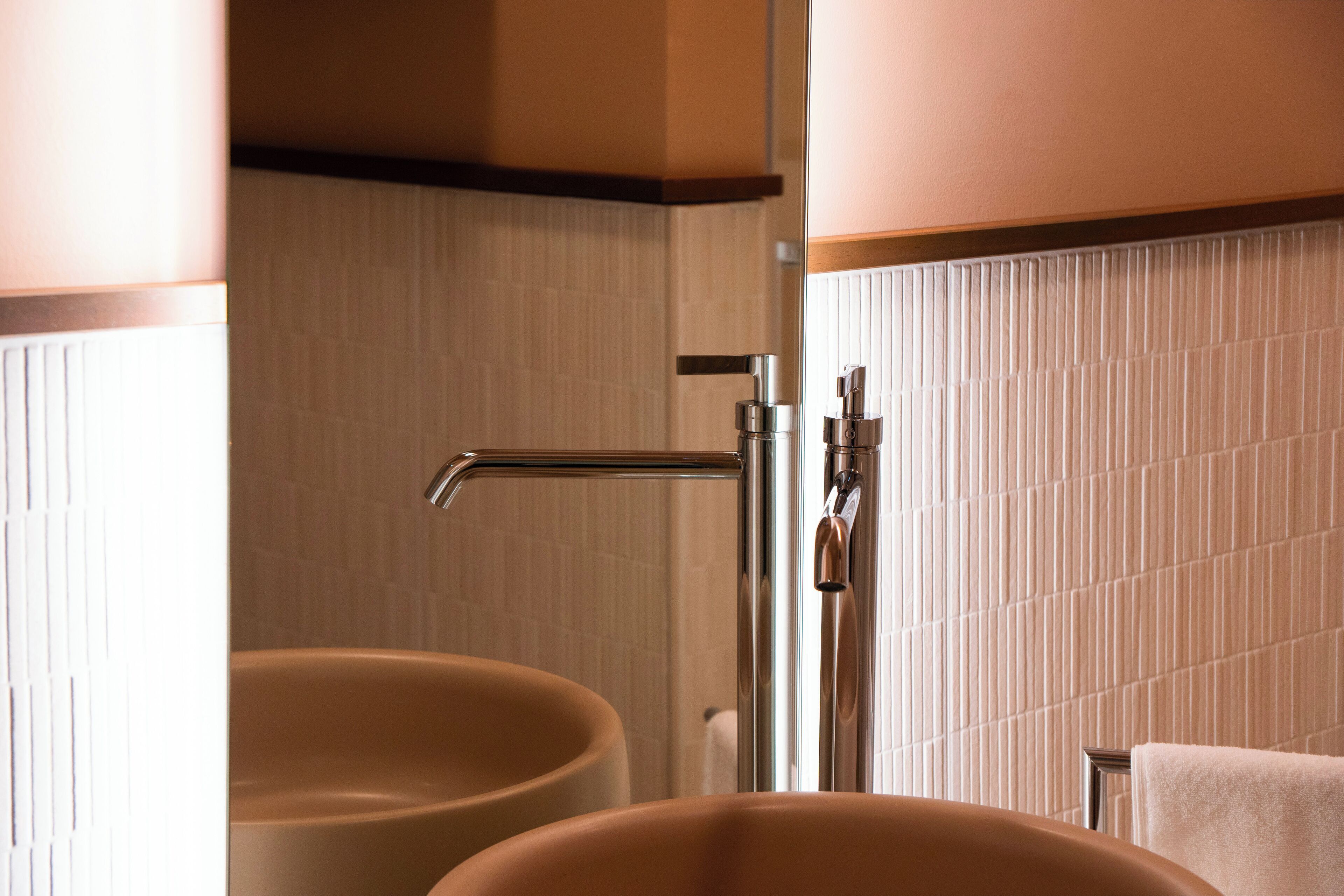 A bathroom with two sinks and a shower.