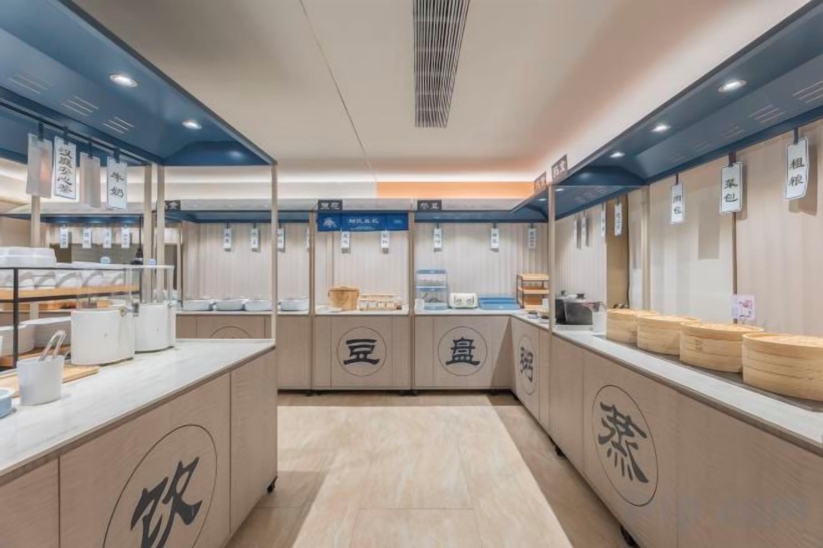 A modern interior with a central counter, display cases, and signage.