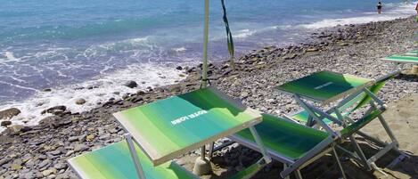 Private beach, black sand, sun loungers, beach umbrellas