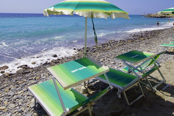 Private beach, black sand, sun loungers, beach umbrellas