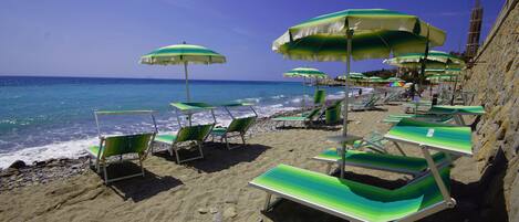 Private beach, black sand, sun-loungers, beach umbrellas