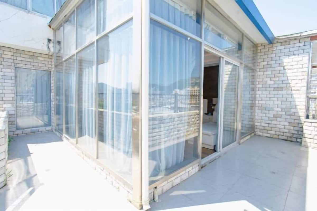 A modern building with large glass windows, a brick exterior, and a flat roof.