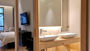 A modern bathroom with a large mirror, two sinks, and a shower. - Yiwenge Hotel (Changshu)