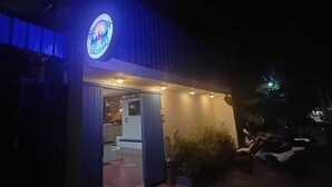 A building with a prominent 'Summer' sign, an open entrance, and a well-lit interior. - Last Summer Hostel & Bar (Siem Reap)