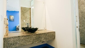 A bathroom with a granite countertop, a black bowl sink, and a mirror. - Last Summer Hostel & Bar (Siem Reap)