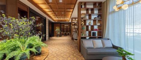A modern interior with a wooden ceiling, a sofa, a table with plants, and a bookshelf.