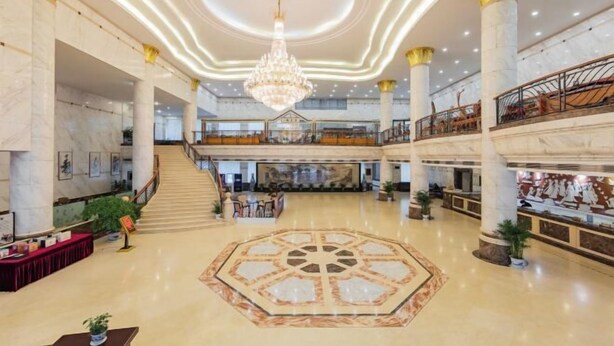 A spacious lobby with a central chandelier, marble flooring, and a staircase leading to upper levels. - Zhaojun Mountain Villa (Xingshan High-speed Railway Station) (Xingshan)