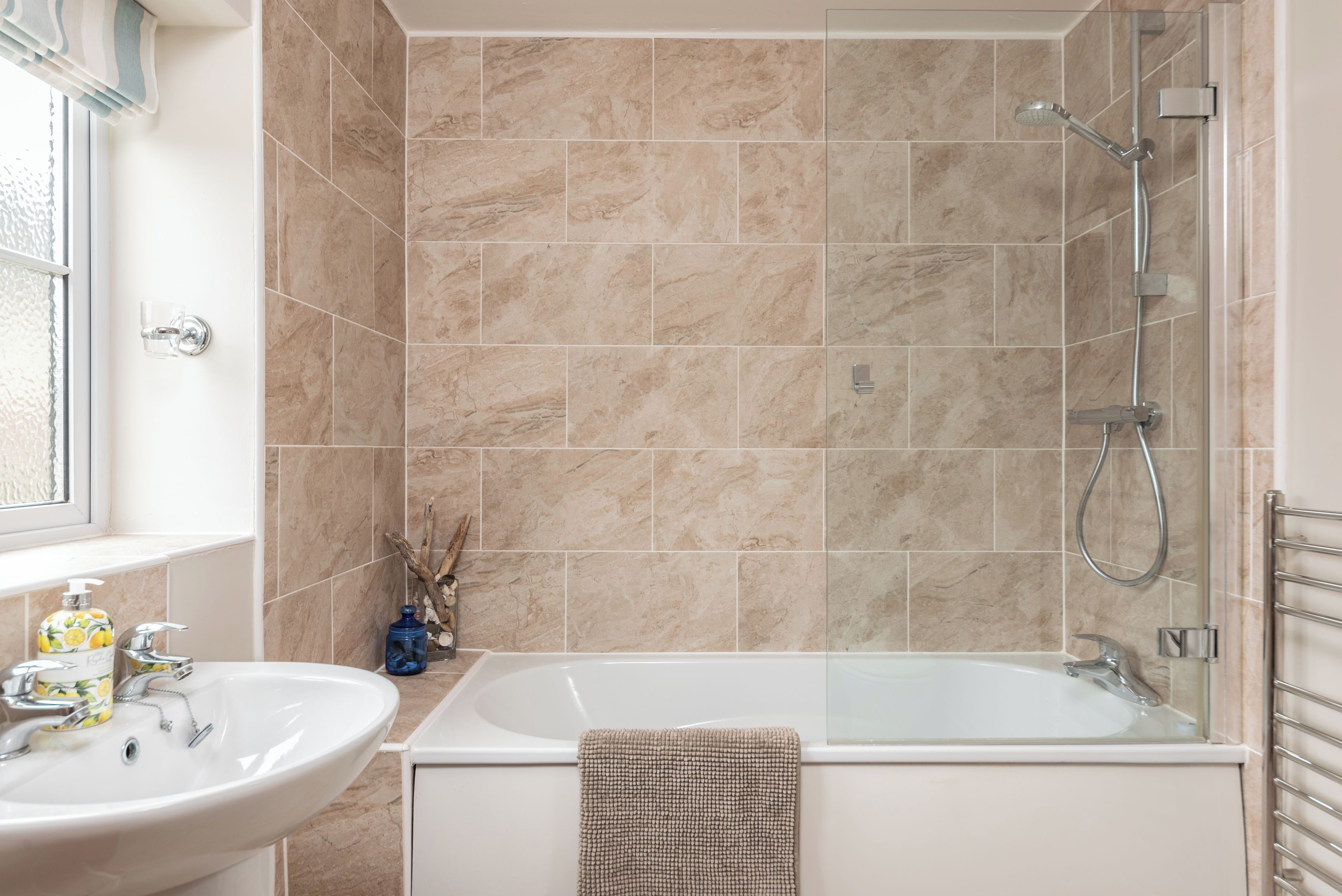 A bathroom with a sink, bathtub, and shower.