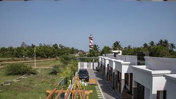 A modern building with a clear view of a lighthouse in the distance.